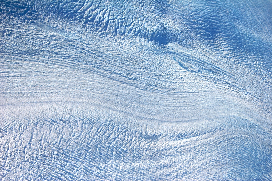 Glacial flow near Jakobshavn appears as a river of moving ice on an ice-sheet.