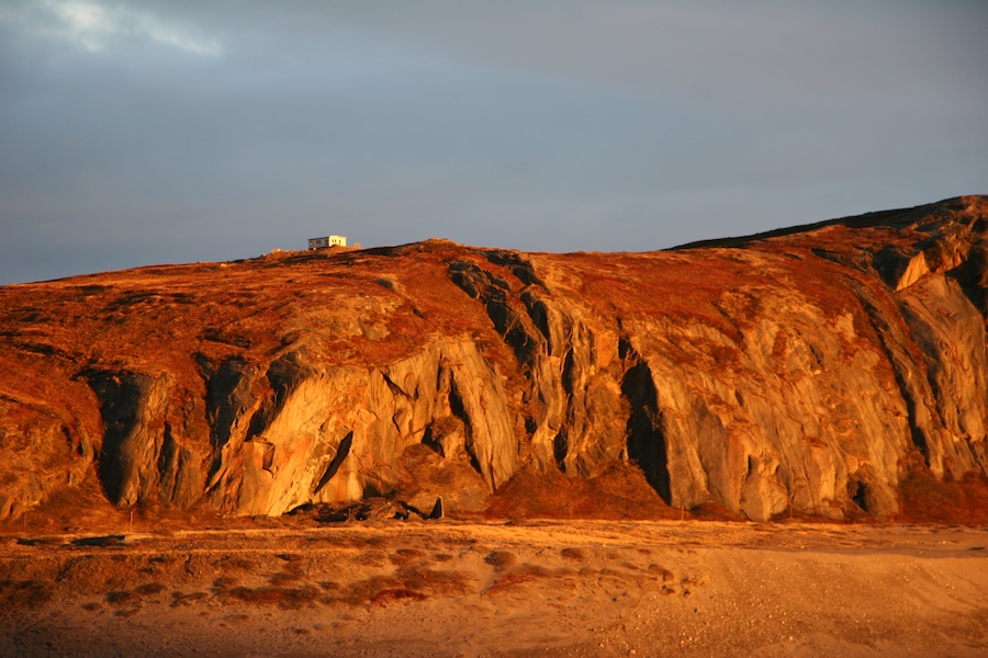This hut near Søndre Strømfjord  is bathed in the seemingly eternal sunset of the arctic latitudes. It belongs to a scientific outpost used to study electromagnetic phenomena such as the aurora borealis.